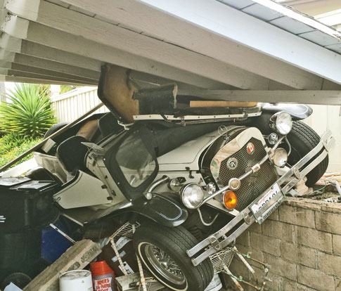 The Car Slammed Through Jim's Gate, Knocked Down this Roof, and Smashed Stored Items.