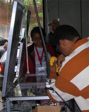 Chris drills holes to mount pneumatic components.